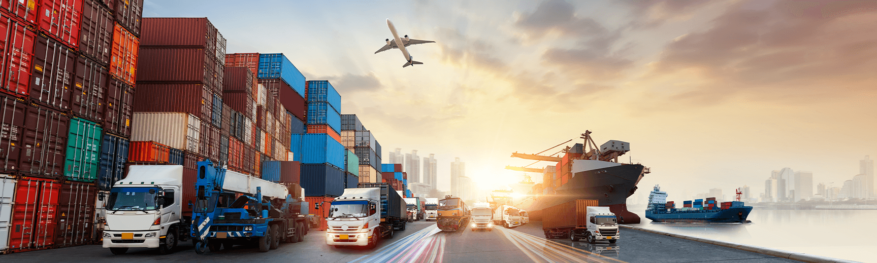 An edited image shows various types of transportation, including a road with semis, a train, a cargo ship, cargo containers, and an airplane flying overhead