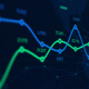 A digital screen shows a green line and a blue line showing the ups and down of financial markets